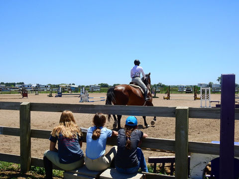 Riders and families at the outdoor arena